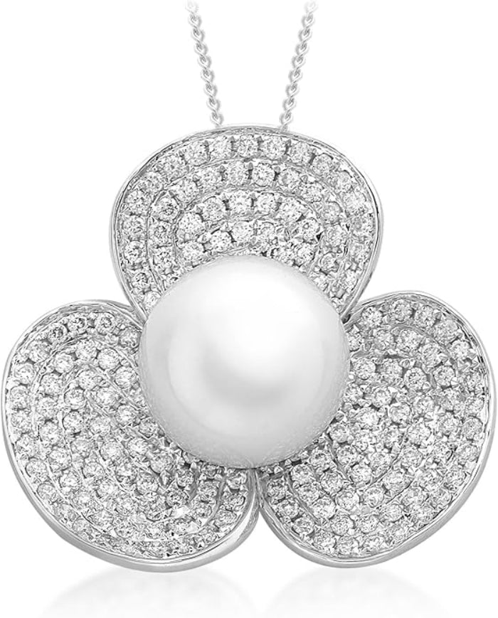 A silver-tone floral pendant necklace featuring a large white pearl at the center, surrounded by three petal-shaped sections paved with small clear stones, shown on a white background.