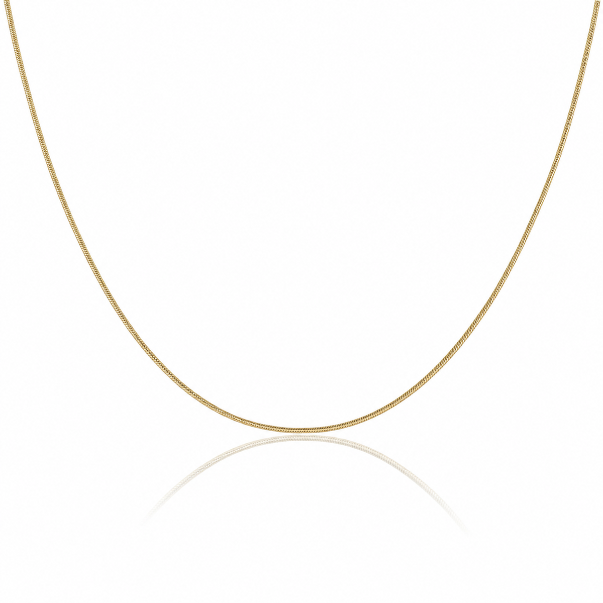 A delicate yellow gold chain necklace forming a U-shape against a clean white background with a soft reflection below.