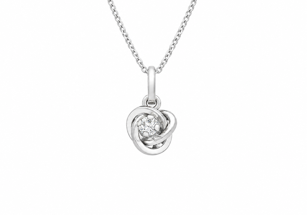 A silver necklace with a knot pendant featuring a small clear gemstone in the center, shown against a plain white background.