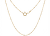 A delicate yellow gold chain necklace with a central ring clasp, displayed against a solid white background.