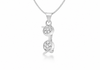 A silver pendant necklace featuring two stacked, vertically aligned oval charms, each adorned with a small cluster of clear pavé gemstones, suspended from a delicate silver chain against a white background.