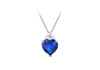 A heart-shaped blue gemstone pendant necklace in a silver-toned setting with a small clear stone above it, suspended from a silver chain on a white background.